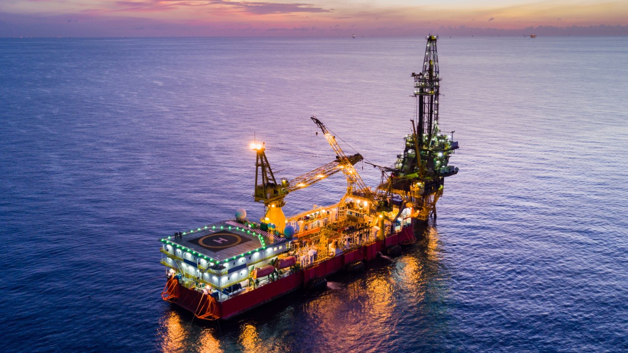 Aerial View of Tender Drilling Oil Rig (Barge Oil Rig) in The Middle of The Ocean at Surise Time
