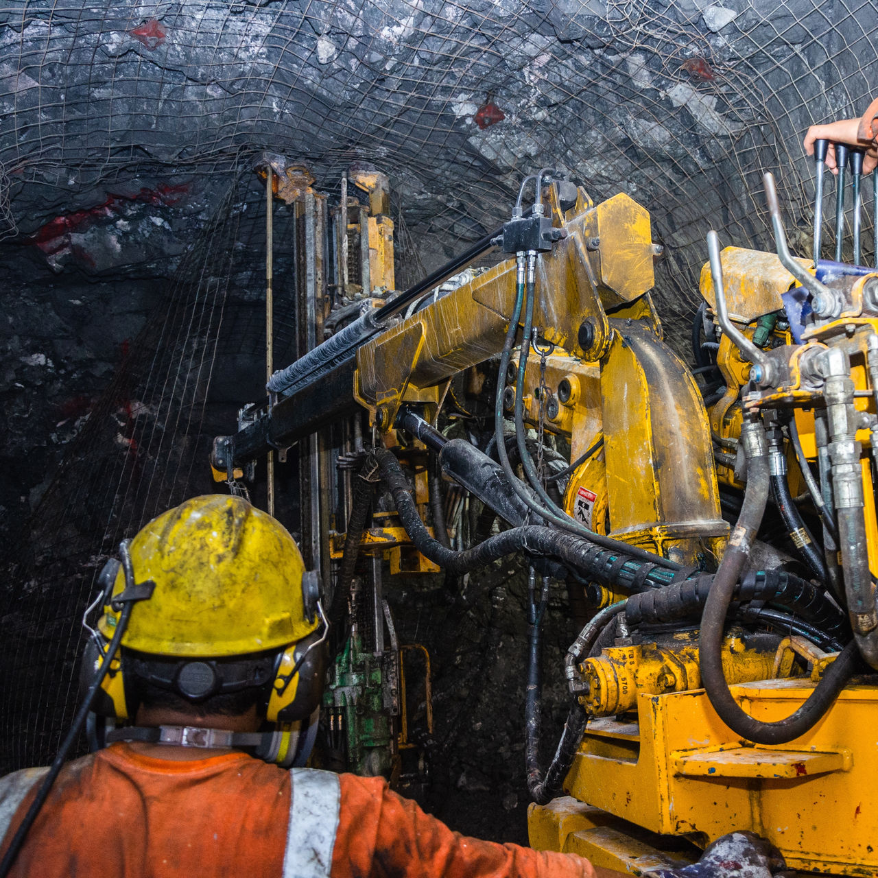 Mining operator on mining machine, underground mine mesh