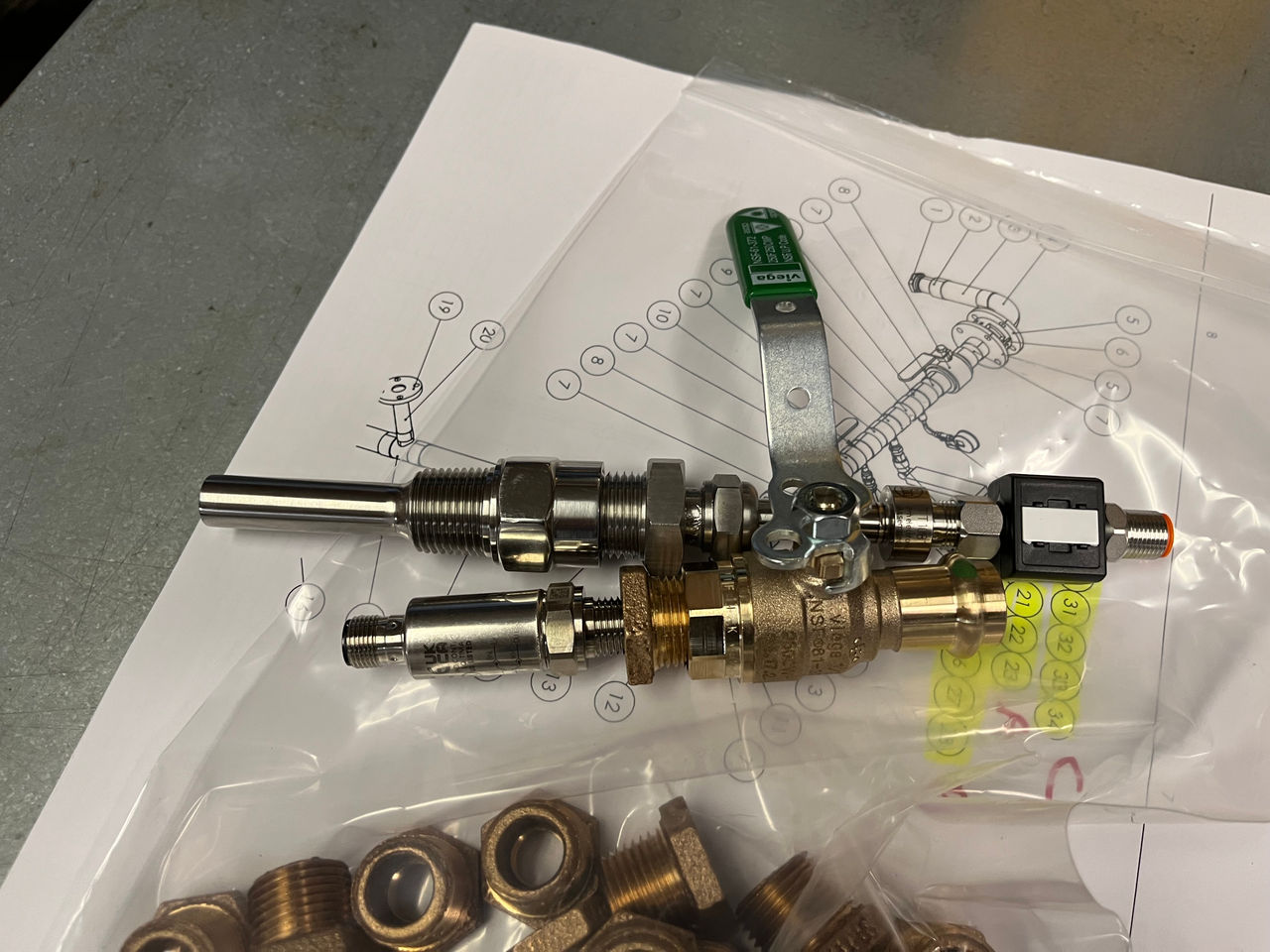 A close-up of a metal valve assembly featuring brass and stainless steel components.