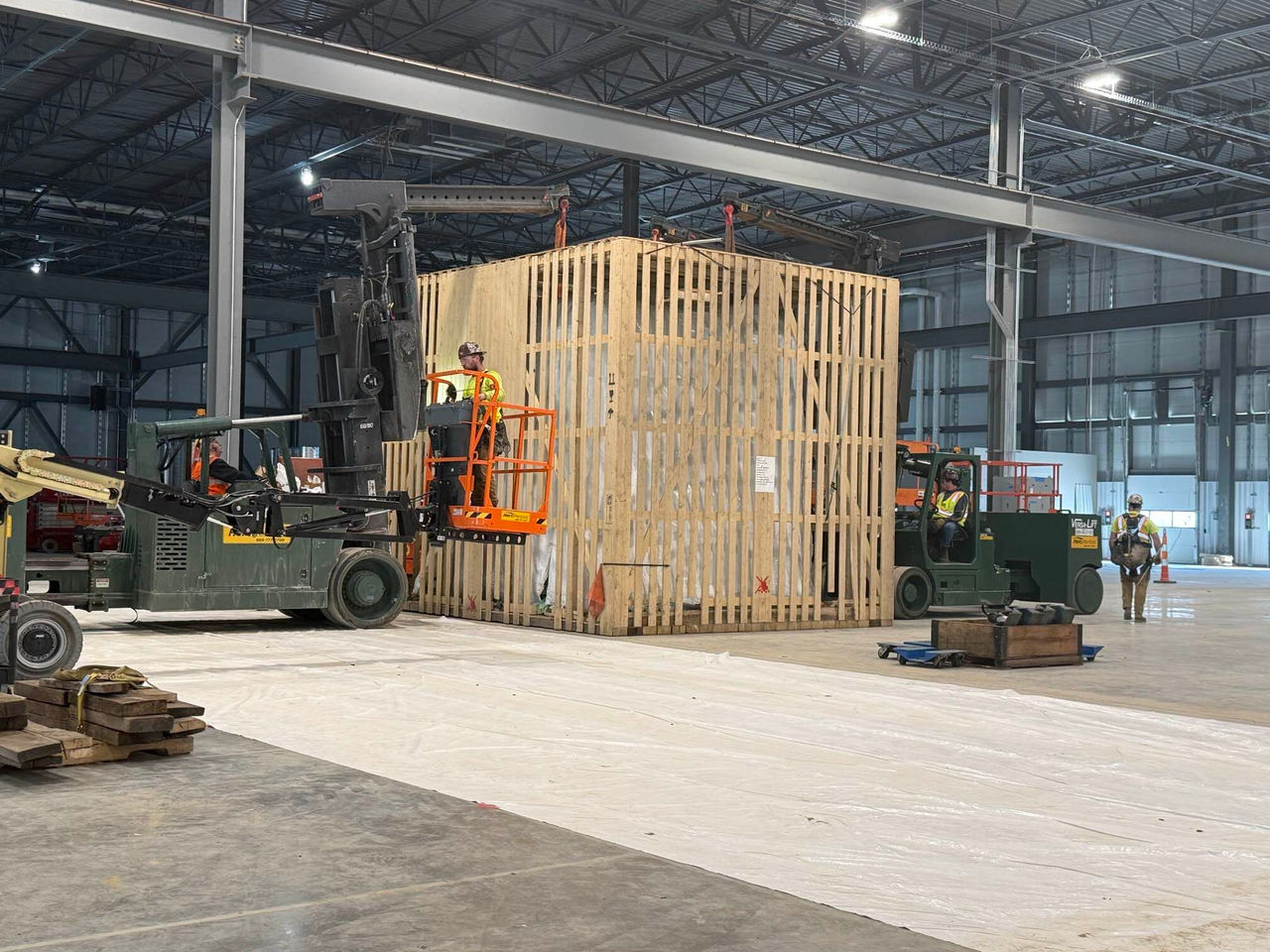 Forklifts moving large pallet