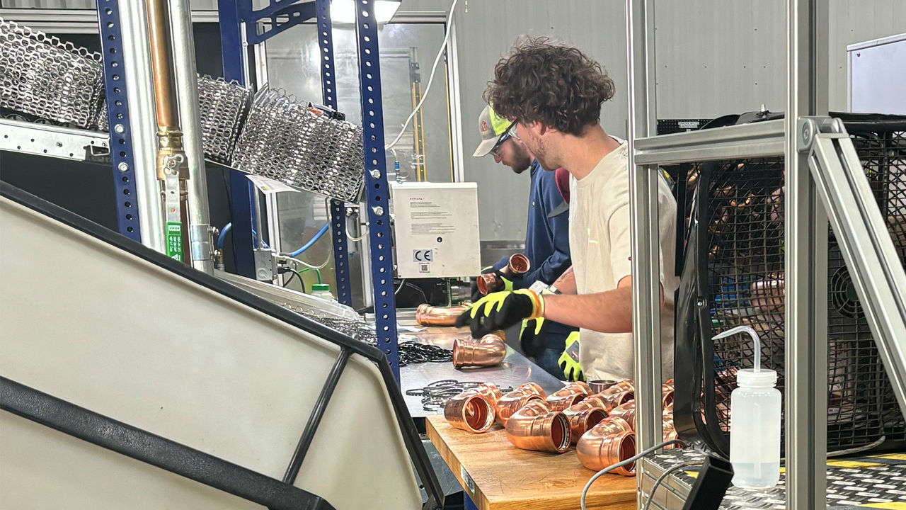 People working on ProPress production line 